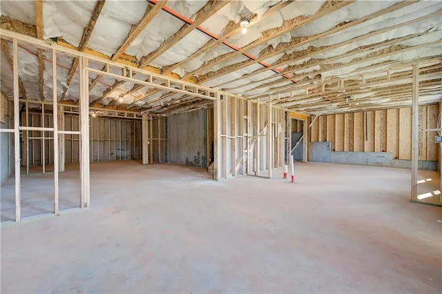 a view of a hallway with wooden floor and a ceiling fan