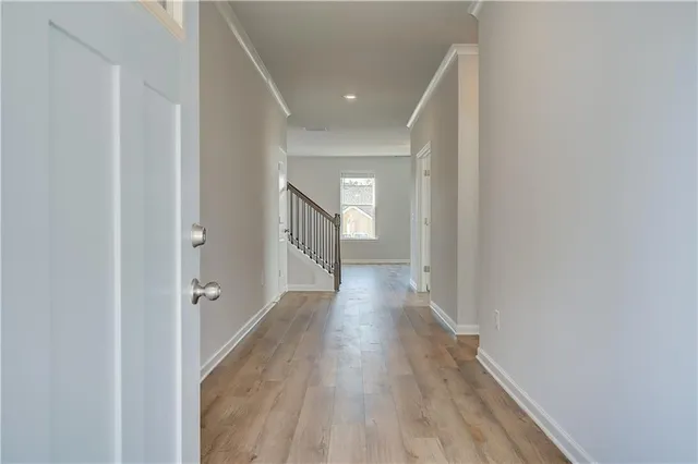 a view of a hallway with wooden floor