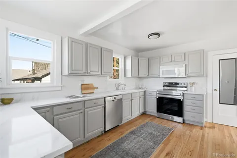 a kitchen with stainless steel appliances granite countertop a stove and a sink