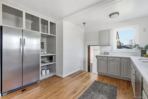 a kitchen with stainless steel appliances granite countertop a refrigerator and a stove top oven