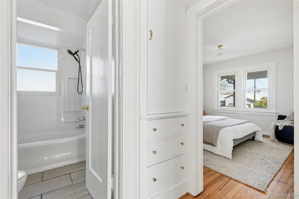 a view of a room with wooden floor and a ceiling fan