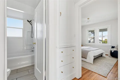 a spacious bedroom with a bed and a large window