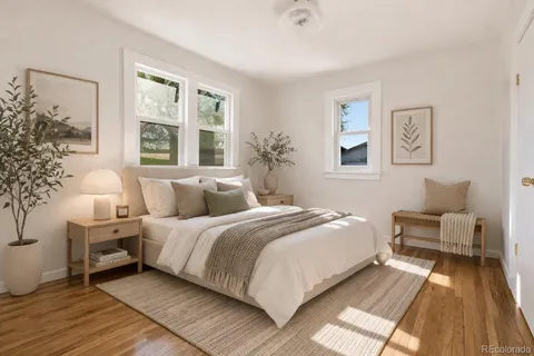 a view of a room with wooden floor and a ceiling fan