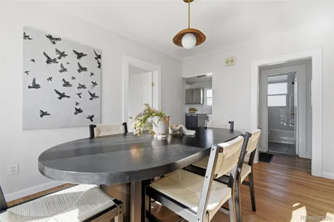 a dining room with furniture and wooden floor