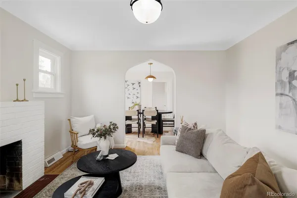 a living room with furniture and a fireplace