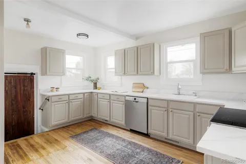 a kitchen that has a sink and a stove in it