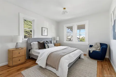 a bedroom with a bed and wooden floor