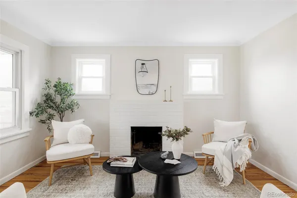 a living room with furniture a window and a fireplace
