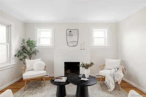 a living room with furniture a window and a fireplace