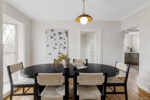 a view of a dining room with furniture and wooden floor