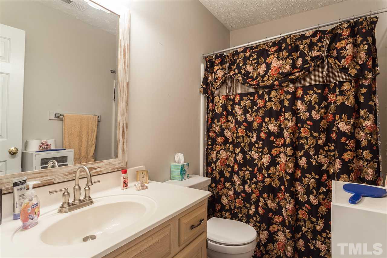 5405 Spring Pines Way Raleigh, NC 27616 - Photo 22 of 30 a bathroom with a sink toilet and shower