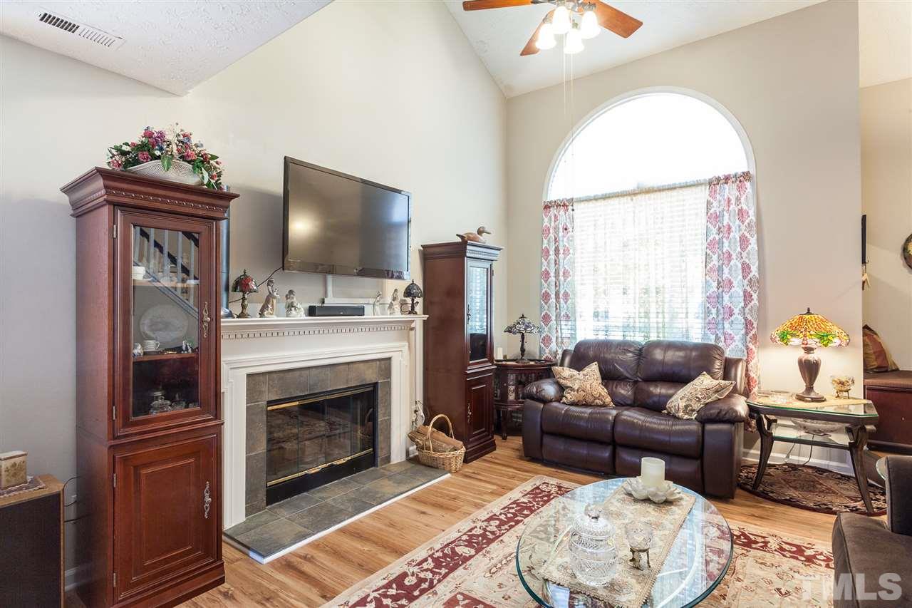 5405 Spring Pines Way Raleigh, NC 27616 - Photo 8 of 30 a living room with furniture a window and a fireplace