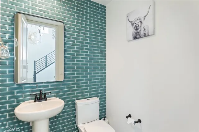 a bathroom with a sink mirror and toilet