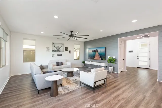 a living room with fireplace furniture and wooden floor