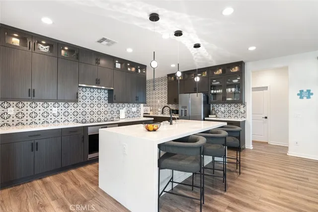 a kitchen with granite countertop a sink and cabinets