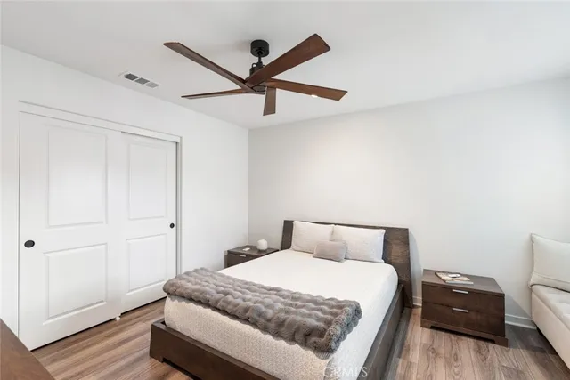 a bedroom with a bed and a ceiling fan