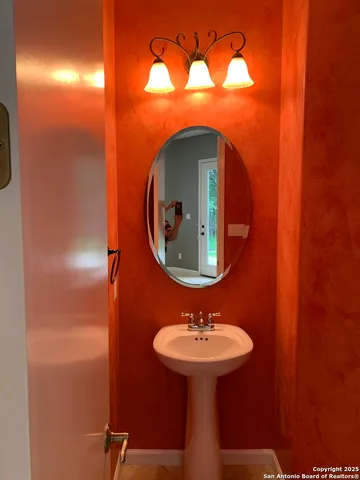 a bathroom with a sink and mirror