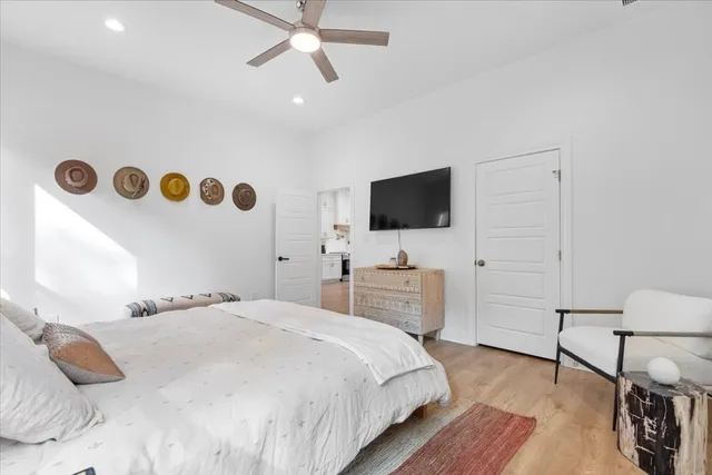 a bedroom with a bed and flat screen tv