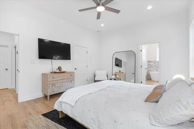 a bedroom with a bed and a flat screen tv