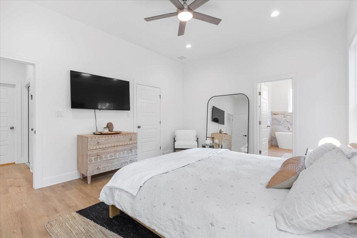 133 Lake Point Way Bastrop, TX 78602 - Photo 15 of 34 a bedroom with a bed and a flat screen tv