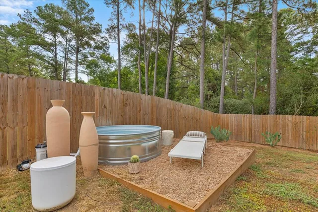 a backyard of a house with table and chairs