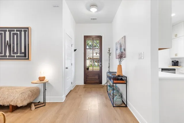 a view of a bedroom with furniture and wooden floor