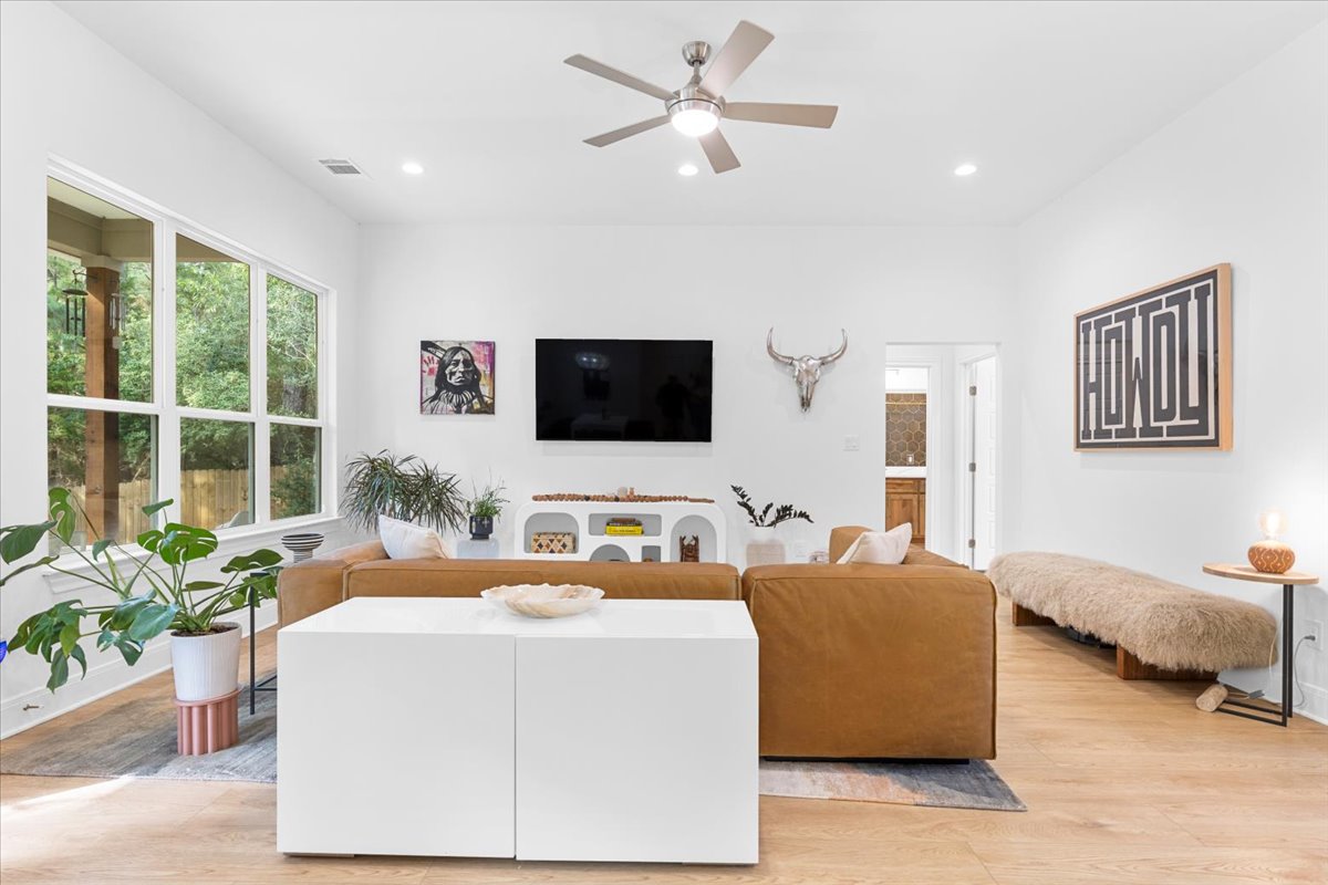 133 Lake Point Way Bastrop, TX 78602 - Photo 6 of 34 a living room with furniture and a flat screen tv