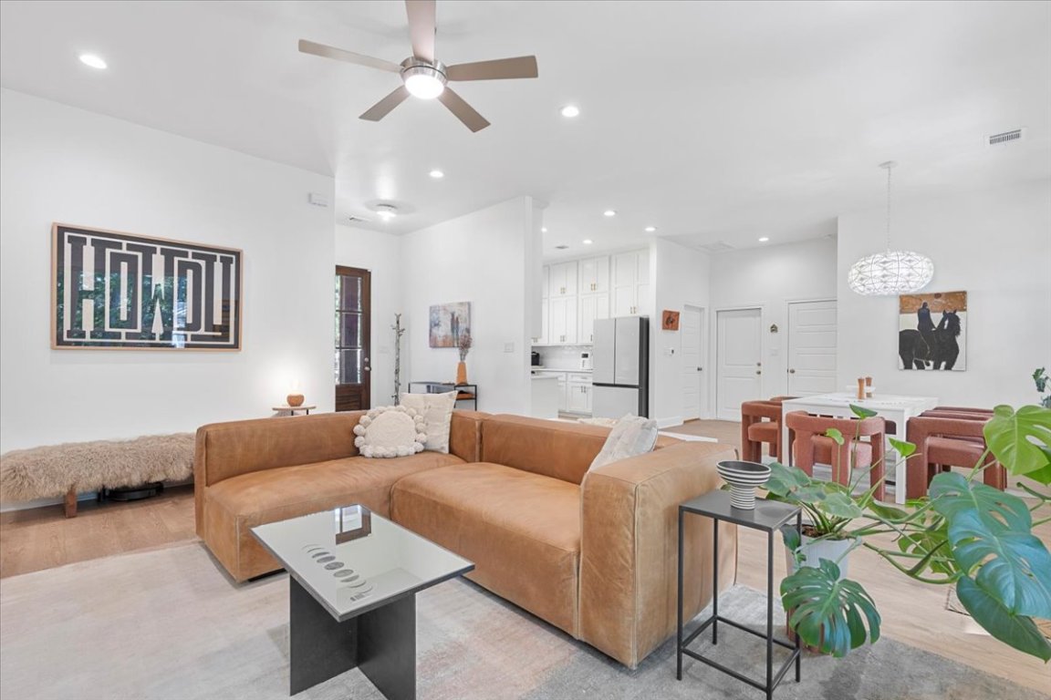 133 Lake Point Way Bastrop, TX 78602 - Photo 7 of 34 a living room with furniture and a view of kitchen