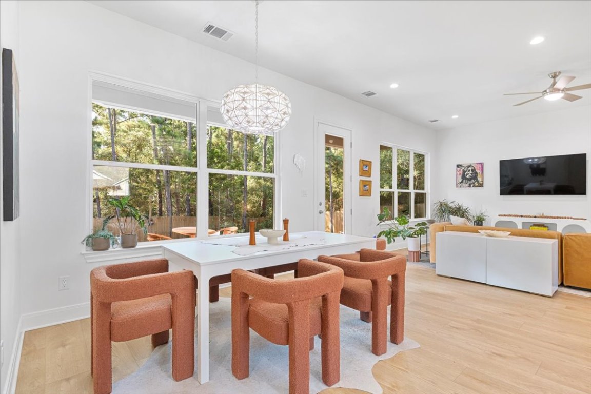 133 Lake Point Way Bastrop, TX 78602 - Photo 9 of 34 a view of a dining room with furniture a livingroom and chandelier