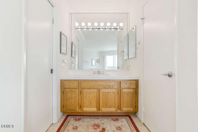 2901 Peninsula Road, Unit 351 Oxnard, CA 93035 - Photo 11 of 45 a bathroom with a sink a mirror and a vanity
