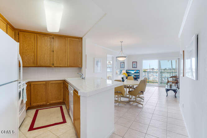 2901 Peninsula Road, Unit 351 Oxnard, CA 93035 - Photo 4 of 45 a view of a kitchen with dining table and chairs