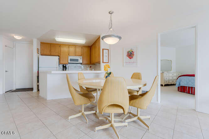 2901 Peninsula Road, Unit 351 Oxnard, CA 93035 - Photo 7 of 45 a dining room with furniture and a chandelier