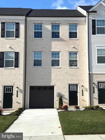 a building with couches fire pit and a yard