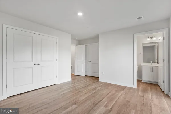 a view of a room with wooden floor and white doors
