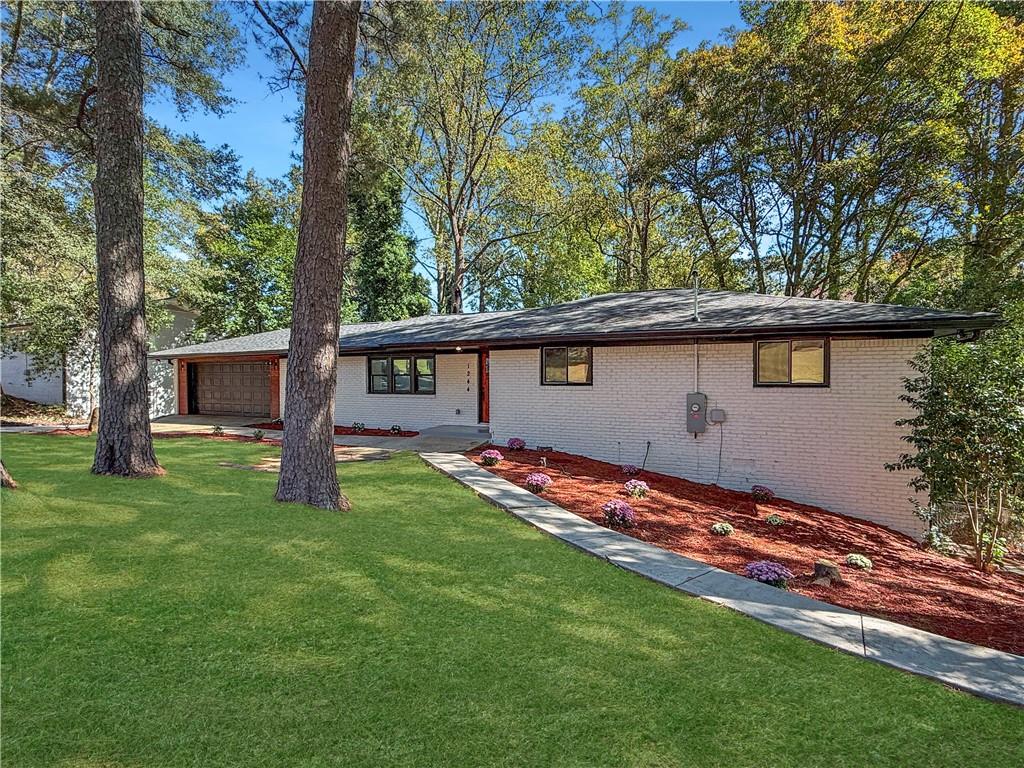 a backyard of a house with table and chairs
