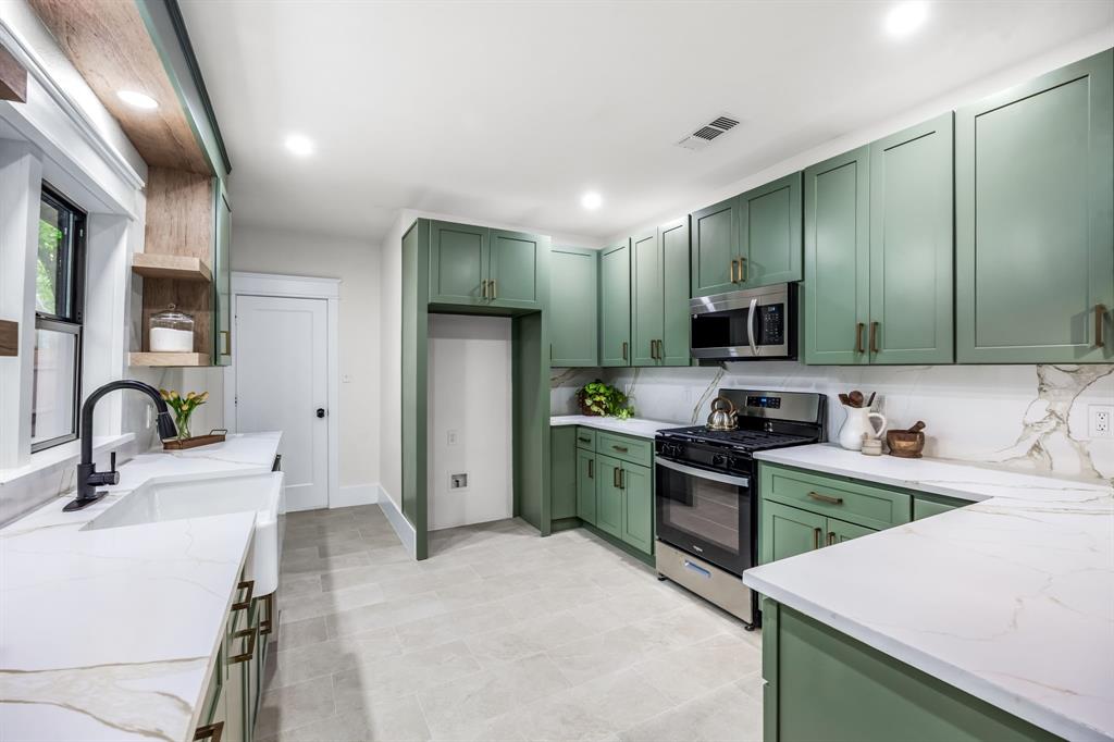 1014 Bolivar Street Denton, TX 76201 - Photo 14 of 36 a kitchen with a sink cabinets and appliances