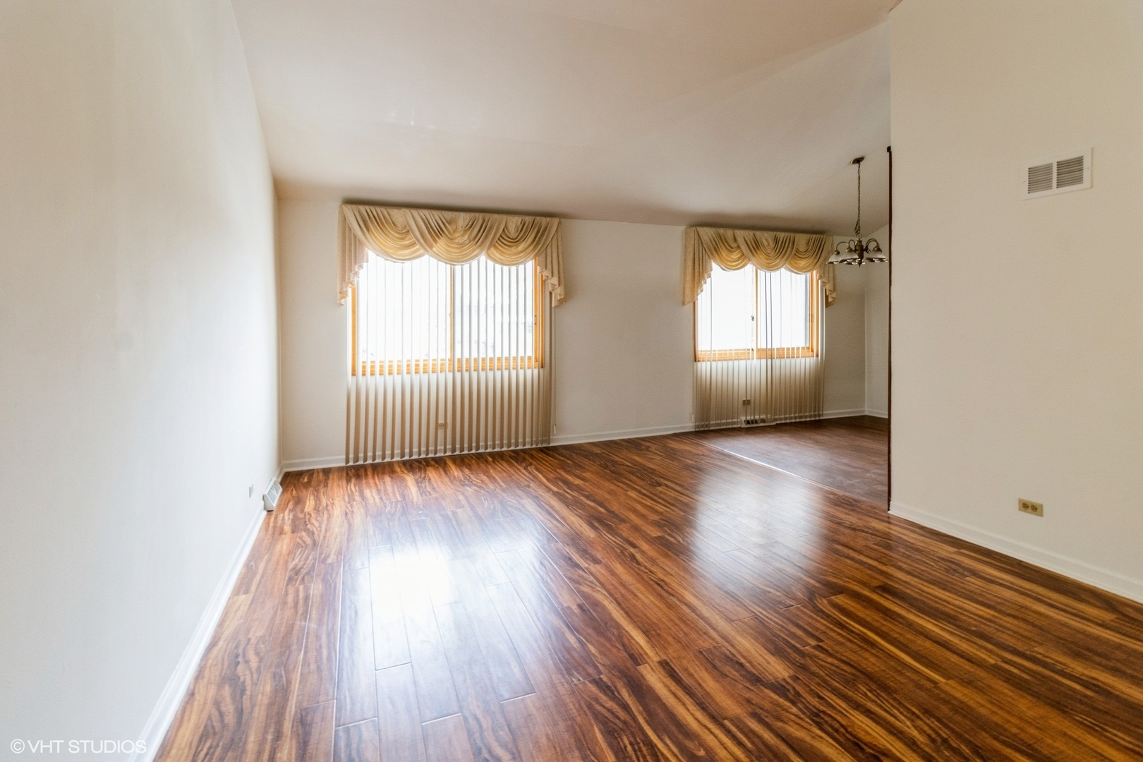 659 High Ridge Road Roselle, IL 60172 - Photo 3 of 16 an empty room with wooden floor and windows