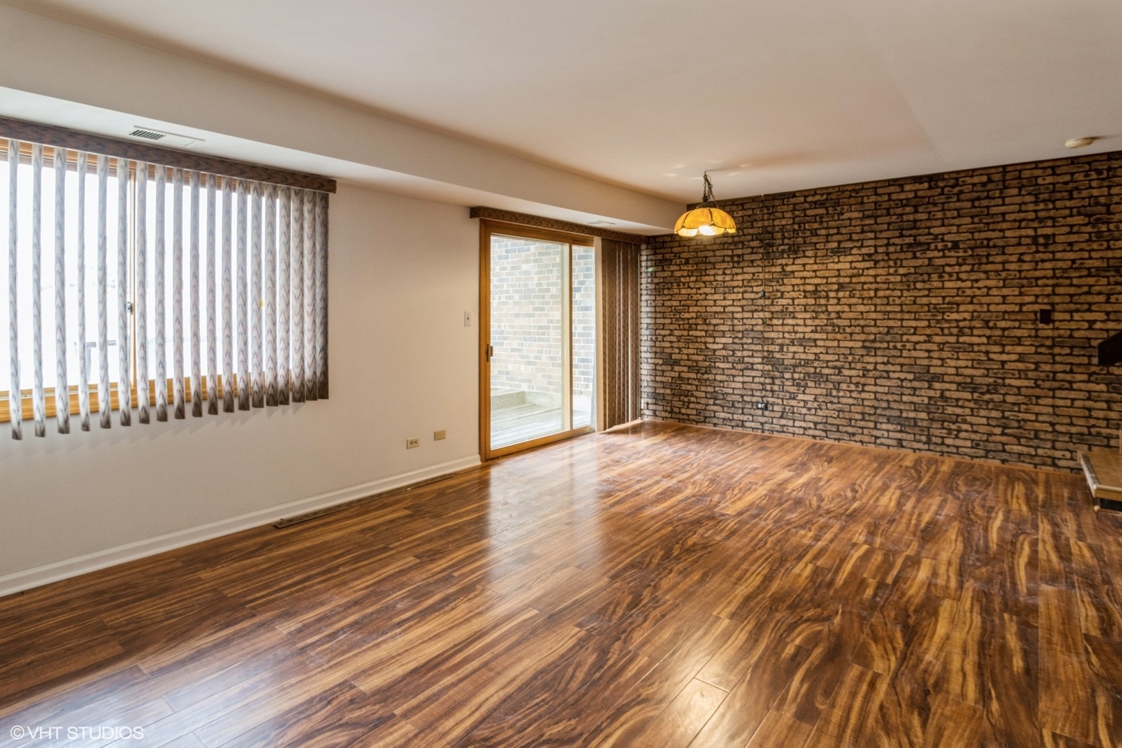 659 High Ridge Road Roselle, IL 60172 - Photo 5 of 16 a view of an empty room with wooden floor and a window