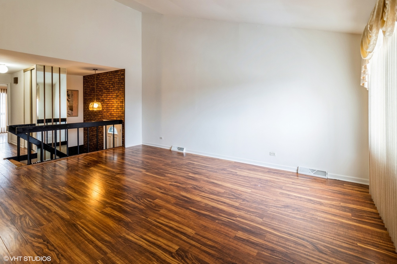 659 High Ridge Road Roselle, IL 60172 - Photo 7 of 16 a view of an empty room with window and wooden floor