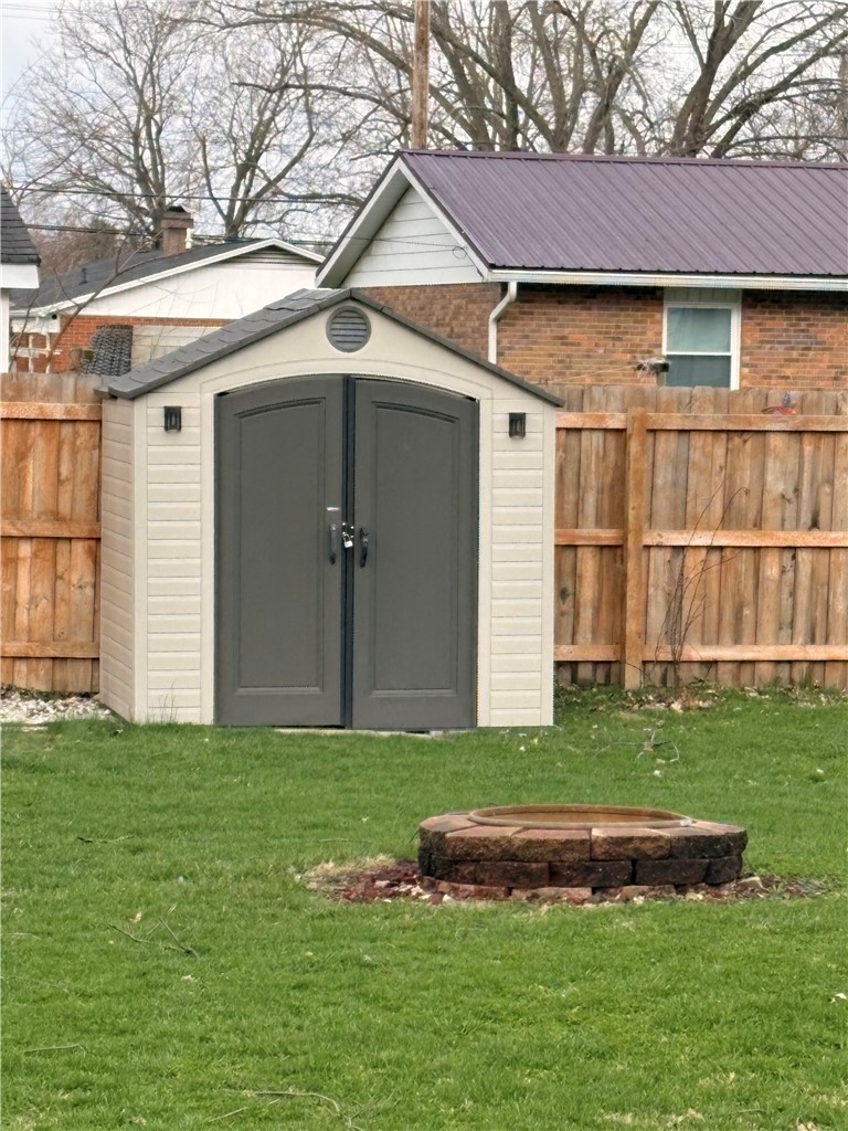 321 Liberty Street Eaton, OH 45320 - Photo 13 of 34 This outdoor space includes a functional shed and a charming fire pit, perfect for gatherings.