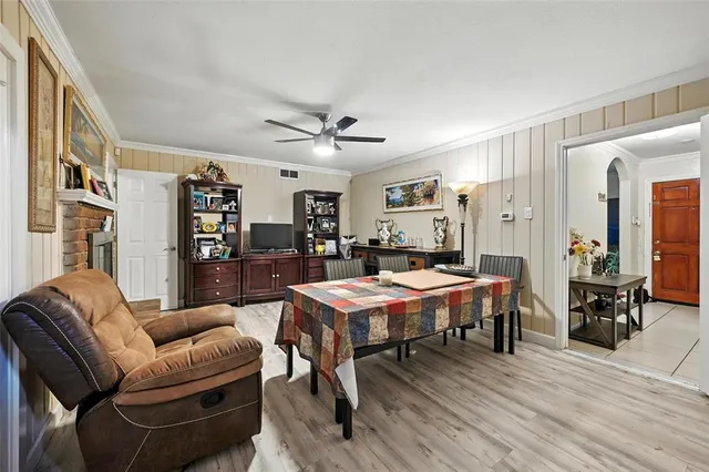a living room with furniture a table and wooden floor