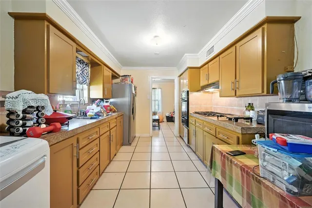 a kitchen with stainless steel appliances granite countertop a stove a sink dishwasher and cabinets with wooden floor