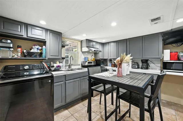 a kitchen with stainless steel appliances granite countertop a stove refrigerator sink and cabinets