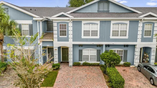 a aerial view of a brick house next to a yard