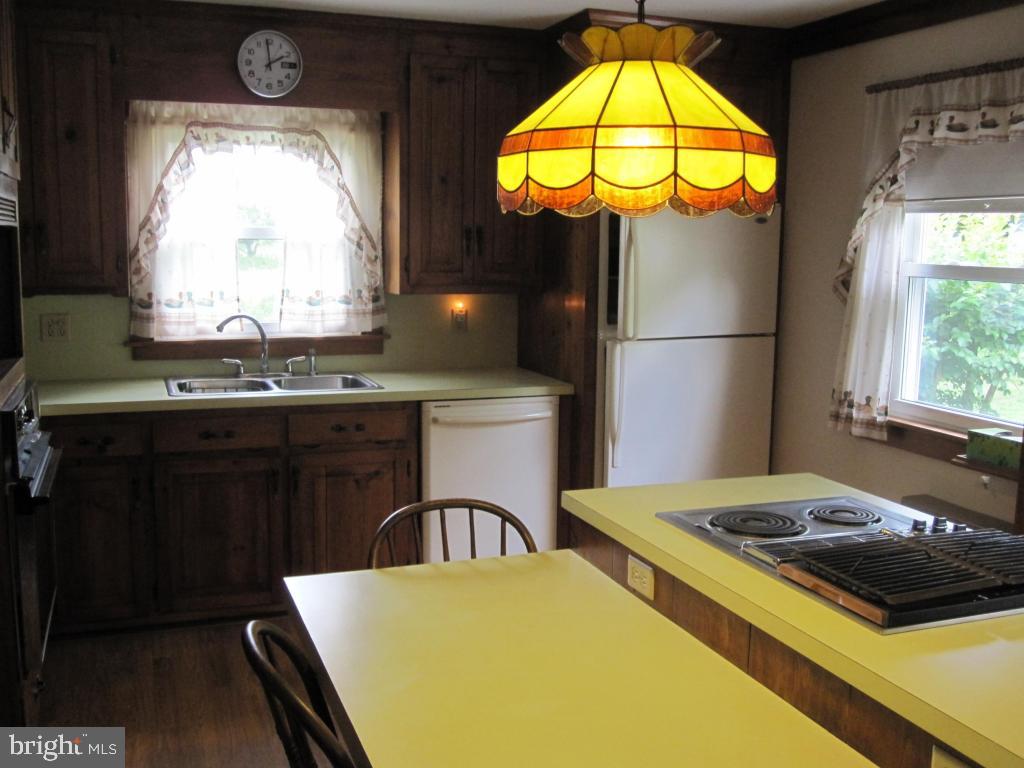 971 Letort Road Washington Boro, PA 17582 - Photo 11 of 29 a kitchen with a sink a stove and a dining table