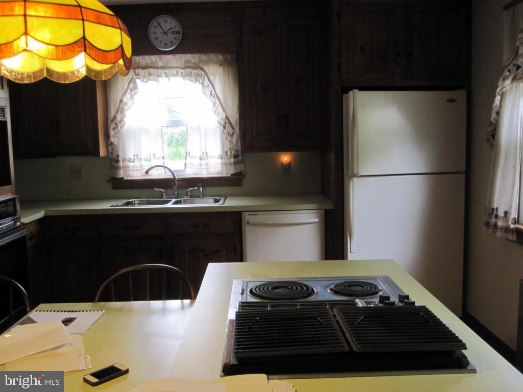 971 Letort Road Washington Boro, PA 17582 - Photo 12 of 29 a kitchen with a refrigerator and a stove