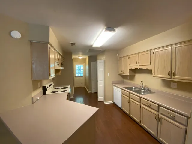 a kitchen with a sink stove and cabinets