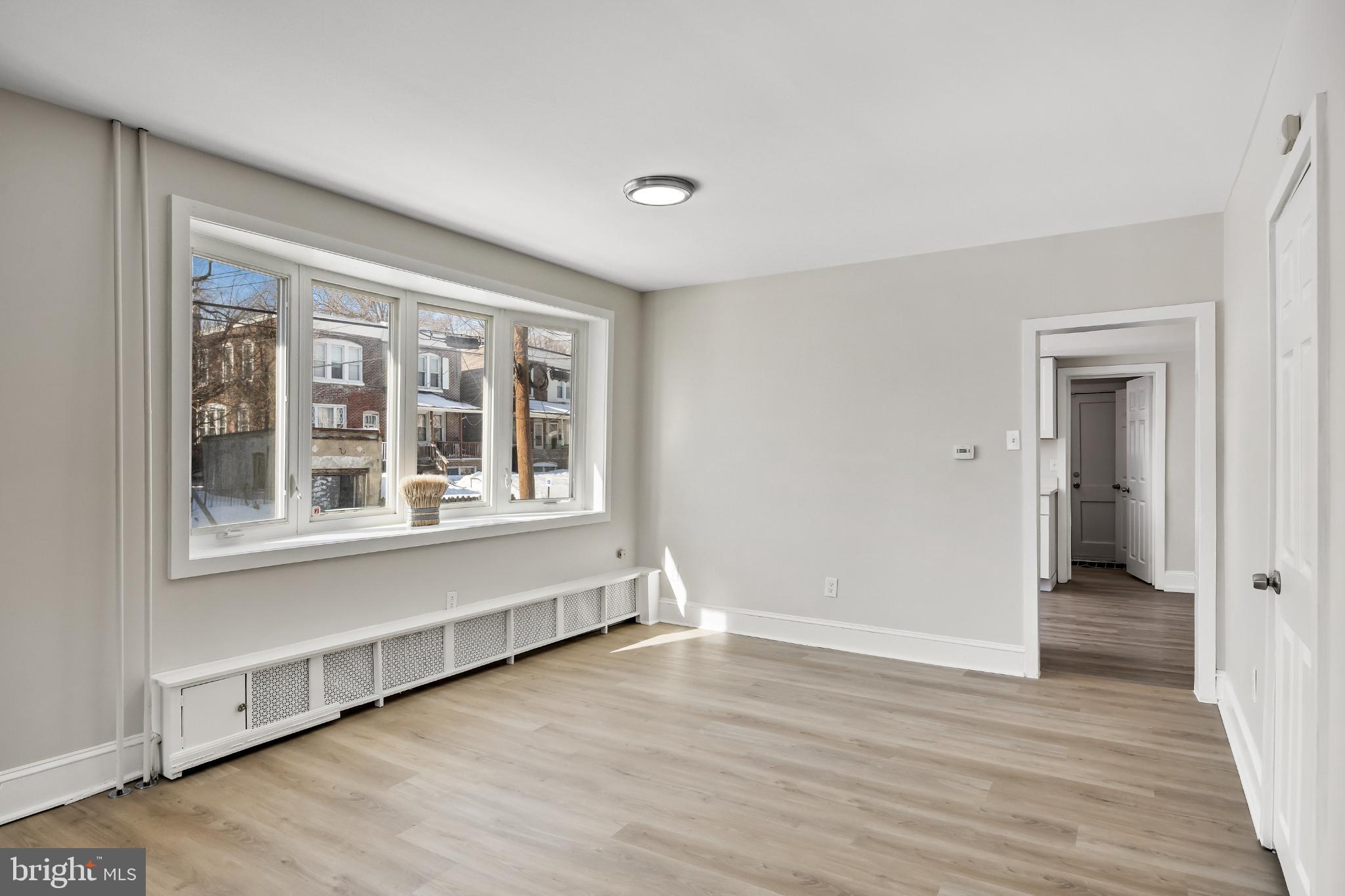 720 West 11th Street Chester, PA 19013 - Photo 11 of 33 a view of an empty room with wooden floor and a window