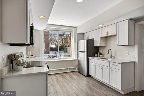 a kitchen with a sink stove and cabinets