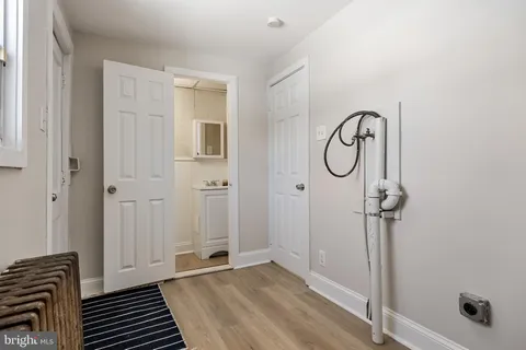 a view of a room with wooden floor and white walls